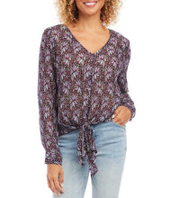 Load image into Gallery viewer, This gorgeous top is crafted with a soft crinkled knit fabric that drapes and flatters. It features a V-neckline, long cuffed sleeves, and a loose fit. Shimmering metallic threading glistens among the floral pattern and really draws the eye. The timeless tie front hemline completes the look. Color- Shades of purple and metallic. Metallic crinkled knit fabrication. V-neckline.  Long cuffed sleeves. Loose fit. Tie front hemline.
