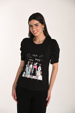 Load image into Gallery viewer, Woman wearing a black t-shirt with graphic design on a white background.
