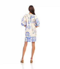 Load image into Gallery viewer, Woman wearing a blue and cream floral dress against a white background.
