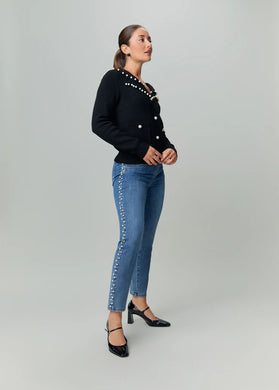 Make a statement with our Patrice Pull-On Pencil Ankle Denim, adorned with elegant pearl embellishments running down the outer side of each leg. This piece also includes a 5-pocket design and a faux zipper closure, adding a touch of contemporary style.