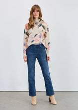Load image into Gallery viewer, Woman wearing a floral sweater, blue jeans and beige boots against a white background.
