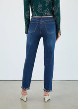Load image into Gallery viewer, Model wearing a green floral top, blue jeans with silver belt and sparkle ruffle hem and off-white heels against a white background.
