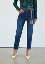 Load image into Gallery viewer, Model wearing a green floral top, blue jeans with silver belt and sparkle ruffle hem and off-white heels against a white background.
