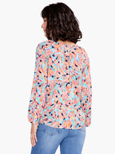 Load image into Gallery viewer, Take a peek at your new favorite colorful top for dressing up or down. Beautiful spring/summer colors pop on this fabulous top includes a keyhole negative space detail that draws the eye. An easy fitting round neck top with 3/4 elastic cuff sleeves complete the look. Designed to sit slightly below the hip.   Colors- Blues, orange, coral, pink, black. Easy fit. Round neck. 3/4 sleeve. Bishop sleeve.
