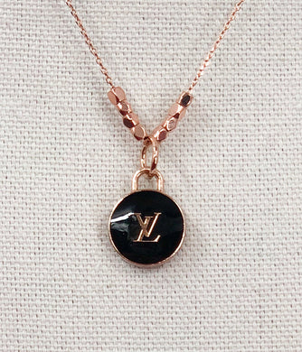 This delicate, yet bold, vintage Louis Vuitton Zipper Pull necklace in rose gold, gold and black is sure to become an essential piece in your collection. With its timeless style, it is perfect for everyday wear, adding a touch of elegance to any outfit.