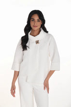 Load image into Gallery viewer, Woman wearing a white swing jacket and white pants against a white background.
