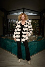 Load image into Gallery viewer, This stunning coat will surely make heads turn as you make an entrance. Combining luxurious faux fur with a striking black and white geometric pattern, this reversible coat adds a touch of chic French sophistication. It features practical pockets and a buttoned closure, seamlessly blending avant-garde fashion with timeless grace in a sleek and compact form.
