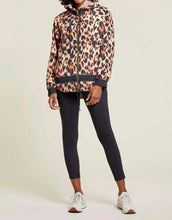 Load image into Gallery viewer, Prepare for the unpredictable weather of spring and summer with a versatile windbreaker and rain jacket. Stay warm and dry on cool, windy, and rainy days with this lightweight and reversible design. Choose between a chic tan color with black stripes or a bold black and orange animal print pattern. A must-have addition to any wardrobe.

