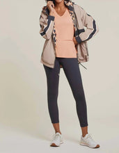 Load image into Gallery viewer, Prepare for the unpredictable weather of spring and summer with a versatile windbreaker and rain jacket. Stay warm and dry on cool, windy, and rainy days with this lightweight and reversible design. Choose between a chic tan color with black stripes or a bold black and orange animal print pattern. A must-have addition to any wardrobe.
