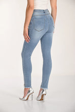 Load image into Gallery viewer, Light blue skinny jeans with and silver heels worn by a model on a white background.
