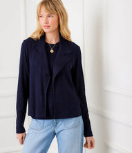 Load image into Gallery viewer, Woman wearing a navy jacket and light blue jeans against a white background.
