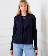 Load image into Gallery viewer, Woman wearing a navy jacket and light blue jeans against a white background.
