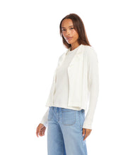 Load image into Gallery viewer, Woman wearing an off-white jacket over an off-white top and blue jeans against a white background.
