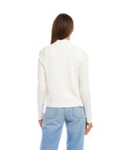 Load image into Gallery viewer, Woman wearing an off-white jacket over an off-white top and blue jeans against a white background.
