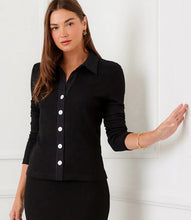 Load image into Gallery viewer, Woman wearing a black button-up shirt and black pants against a white background.
