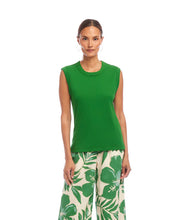 Load image into Gallery viewer, Woman wearing a green sleeveless top and floral and leaf-patterned pants on a white background.

