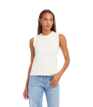 Load image into Gallery viewer, Woman wearing an off-white sleeveless tank top and light blue jeans on a white background.
