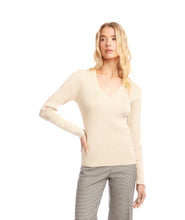 Load image into Gallery viewer, Woman wearing a beige sweater and plaid pants against a white background.

