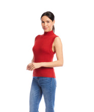 Load image into Gallery viewer, Woman wearing a red sleeveless ribbed turtleneck sweater and blue jeans against a white background.
