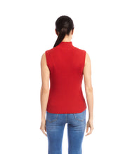 Load image into Gallery viewer, Woman wearing a red sleeveless ribbed turtleneck sweater and blue jeans against a white background.
