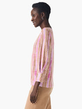 Load image into Gallery viewer, Nic &amp; Zoe has once again exceeded expectations with their latest addition, the Rolling Dunes Sweater. This versatile piece has the appearance of a woven top, but surprises with its lightweight sweater material and a unique printed design in a striking pink and tan on a jersey knit base. Designed with an effortlessly flattering fit and a drapey feel, this sweater features an inverted pleat detail above the 3/4 sleeve cuffs for an added touch of sophistication.
