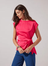 Load image into Gallery viewer, urn heads with the Rosalia Tie Drape Mix Media Top by Lysse—a stunning fusion of elegance and modern flair. Designed in a Pink Martini hue, this top features a graceful draped silhouette and a chic front side tie, effortlessly blending sophistication with a touch of playful charm. Crafted from premium mix-media fabric, it offers a luxurious feel and a flattering fit, making it perfect for both day-to-night styling. Whether paired with tailored trousers or sleek denim, this piece is a must-have.
