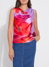 Load image into Gallery viewer, Elevate your wardrobe with the Rosario Draped Printed Top by Lysse, a captivating blend of elegance and effortless charm. Adorned with a floating floral print in a stunning color combination, this piece flows with a graceful drape that flatters every movement. Crafted for both comfort and sophistication, its soft, luxurious fabric and chic silhouette make it a versatile staple—perfect for day-to-night styling. Whether paired with tailored trousers or sleek denim, this top is designed to turn heads.
