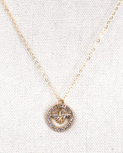 Load image into Gallery viewer, The Rosemary necklace is a stunning piece, featuring a vintage designer button adorned with sparkling rhinestones. Its delicate gold chain adds an extra touch of brilliance. Whether worn alone or layered with other necklaces, this modern piece adds the perfect amount of shine to any outfit, from a simple tee and jeans to a more dressed-up look.
