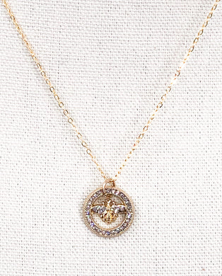 The Rosemary necklace is a stunning piece, featuring a vintage designer button adorned with sparkling rhinestones. Its delicate gold chain adds an extra touch of brilliance. Whether worn alone or layered with other necklaces, this modern piece adds the perfect amount of shine to any outfit, from a simple tee and jeans to a more dressed-up look.