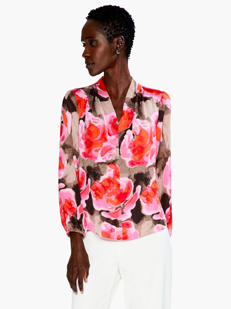 This gorgeous and cheery print of the Rosy Outlook top will brighten any day! Made with comfort in mind, this lightweight top features an elastic cuff, flowing long sleeve, and an easy fit. The band collar elevates the look and provides dress up potential. Sits at the hip.  Color- Pink multi. Lightweight. Easy fit. Band collar Long sleeve Elastic cuff sleeve Sits at hip