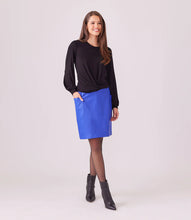 Load image into Gallery viewer, This faux-leather skirt seamlessly blends fashion and functionality, making it a versatile addition to your wardrobe. Featuring functional pockets, it&#39;s perfect for storing essentials and striking a relaxed pose while maintaining a chic and sophisticated appearance from day to night.  Color - Royal blue. Length: 41 Inches (for size 8) Pencil skirt. Elasticized waistband. Fabric- Faux Leather: 50% Viscose, 50% Polyurethane.
