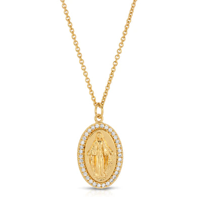 Featuring an oval silhouette pendant, the Saint Mary Necklace highlights Virgin Mary in the center of the drop pendant and is surrounded by cubic zirconia. Perfect to wear as a statement piece or as a layering piece. Color- Gold and clear. Cubic zirconia. 14K Gold plating over brass. 16