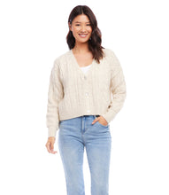 Load image into Gallery viewer, This cardigan sweater features intricate, textured yarns that form a sophisticated cable knit pattern. An ageless piece, it can be dressed up or worn casually for any occasion. Color- Sand. Long sleeve. Button down. Cable knit.
