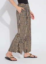 Load image into Gallery viewer, Refined and effortlessly chic, the Santana Pleated Trouser by Lysse is a modern wardrobe essential designed for the woman who values both comfort and sophistication. Crafted from breathable Stretch Woven fabric with 2X stretch, these trousers feature a flattering wide-leg silhouette, deep front pleats, and a concealed tricot front panel that smooths and shapes. The elasticized back waistband ensures a flexible fit, while functional side pockets with mesh facing reduce bulk without sacrificing practicality.

