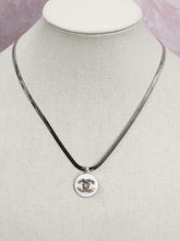 Load image into Gallery viewer, If you love silver jewelry, you will be in awe of this fabulous vintage designer button necklace.  A perfect piece that dazzles from first sight, this unique and gorgeous necklace will demand attention!    Vintage Coco Chanel button. Button color-White, silver, white rhinestone. Herringbone chain. Pendant length-1 inch. Chain length- 18 Inch. Composition- Chain 925 silver. Lobster clasp closure. Handmade repurposed jewelry.
