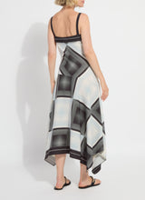 Load image into Gallery viewer, Woman wearing a black and white patterned dress and black sandals on a white background.
