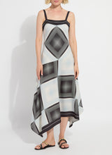 Load image into Gallery viewer, Woman wearing a black and white patterned dress and black sandals on a white background.
