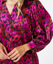 Load image into Gallery viewer, This elegant blouse is crafted from a luxuriously soft satin and features a button-up design with a shirt collar, and delicate pleating on its long-cuffed sleeves. Its versatility allows it to be worn for work and leisure alike.  Color - Magenta, pink and coral. Floral print. Button down. Shirt collar. Subtle pleat detailing on sleeves. Long cuffed sleeves.
