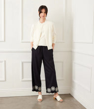 Load image into Gallery viewer, Refined yet effortlessly comfortable, the Sherrit Scallop Drawstring Pants by Karen Kane blend elegance with everyday ease. Crafted from black cotton woven fabric, these wide-leg pants feature delicate cream embroidery and a scalloped hem. Perfect for casual outings, workdays, or evening wear, these versatile embroidered pants pair beautifully with blouses, tanks, or structured tops.
