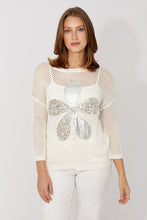Load image into Gallery viewer, Woman wearing a white mesh top with a decorative silver sequin flower and white pants on a plain background.
