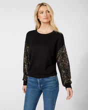 Load image into Gallery viewer, Constructed from a luxuriously soft fabric blend, this top, in a sweatshirt fabrication, is ideal for any type of event, from casual to formal. It pairs beautifully with both denim and skirts and boasts a crew neckline and long sleeves adorned with sequins for a subtle touch of shimmer.
