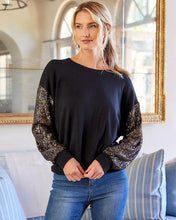 Load image into Gallery viewer, Constructed from a luxuriously soft fabric blend, this top, in a sweatshirt fabrication, is ideal for any type of event, from casual to formal. It pairs beautifully with both denim and skirts and boasts a crew neckline and long sleeves adorned with sequins for a subtle touch of shimmer.
