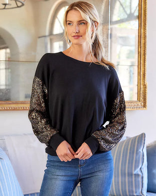 Constructed from a luxuriously soft fabric blend, this top, in a sweatshirt fabrication, is ideal for any type of event, from casual to formal. It pairs beautifully with both denim and skirts and boasts a crew neckline and long sleeves adorned with sequins for a subtle touch of shimmer.