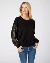 Load image into Gallery viewer, Constructed from a luxuriously soft fabric blend, this top, in a sweatshirt fabrication, is ideal for any type of event, from casual to formal. It pairs beautifully with both denim and skirts and boasts a crew neckline and long sleeves adorned with sequins for a subtle touch of shimmer.
