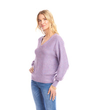 Load image into Gallery viewer, Woman wearing a purple sequin sweater and blue jeans against a white background.
