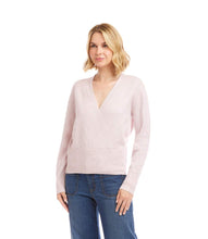Load image into Gallery viewer, Woman wearing a light pink sweater and blue jeans against a white background.
