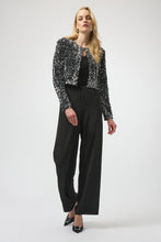 Load image into Gallery viewer, Woman wearing a black and silver sequined long sleeve jacket over a black top and black pants and black pumps against a white background.

