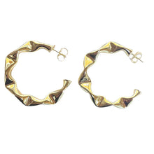 Load image into Gallery viewer, The Sheila Fajl Large Wrinkled Hoops in Shiny Gold are a playful and flirtatious addition to your collection. These hoops are meticulously handcrafted in Brazil and feature a unique wrinkled design, ensuring they stand out as a statement piece. They are made from 18K gold-plated, nickel-free brass, providing both quality and comfort.
