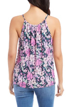 Load image into Gallery viewer, The Karen Kane Shay Shirred Floral Tank is a vibrant, sleeveless top featuring soft shirring and sleek cutaway shoulders for a flattering fit. Designed with a bold floral print in berry, purple, navy, and multicolor hues, this tank adds a fresh, feminine touch to any outfit. Crafted from lightweight, breathable fabric, it’s perfect for layering or wearing solo in warm weather.
