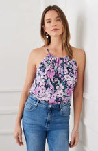 Load image into Gallery viewer, The Karen Kane Shay Shirred Floral Tank is a vibrant, sleeveless top featuring soft shirring and sleek cutaway shoulders for a flattering fit. Designed with a bold floral print in berry, purple, navy, and multicolor hues, this tank adds a fresh, feminine touch to any outfit. Crafted from lightweight, breathable fabric, it’s perfect for layering or wearing solo in warm weather.

